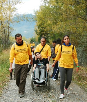 Voluntarios ayudando a una persona en silla de ruedas